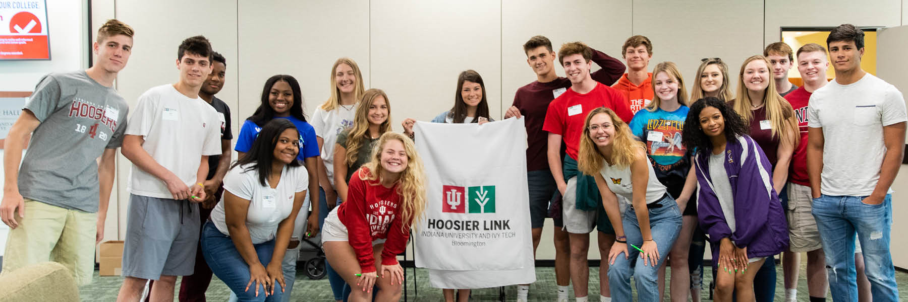 A group of students holding a Hoosier Link banner.